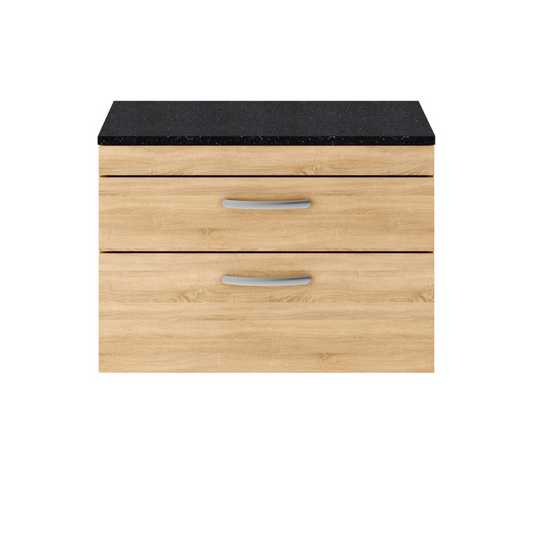 The Nuie Athena Wall Hung 800mm Two Drawer Vanity with Sparkling Black Worktop is a truly beautiful addition to any modern bathroom. The stunning natural oak finish adds a touch of elegance and sophistication, instantly creating a designer look. Not only does this vanity unit enhance the overall aesthetic of the bathroom, but it also serves a practical purpose by creating more space. The wall hung design gives the illusion of a bigger bathroom, making it perfect for smaller spaces. 
