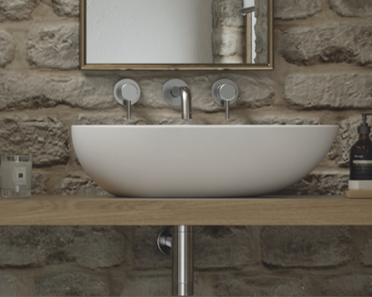 The Oval shaped basin is a sleek and modern addition to any bathroom. Expertly crafted from natural volcanic limestone and high quality resin, this basin boasts durability, strength, and resistance to scratches and chips. Its clean lines and minimalistic design create a sophisticated and chic look that is perfect for modern or contemporary bathrooms.