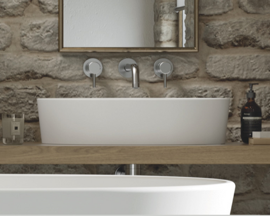 This stone basin is a stunning addition to any modern or contemporary bathroom. This luxurious basin is expertly crafted from natural volcanic limestone and high quality resin, creating a strong and durable surface that is resistant to scratches and chipping. The basin features graceful curves and smooth lines, creating an elegant and sophisticated look that complements the accompanying bathtub perfectly.